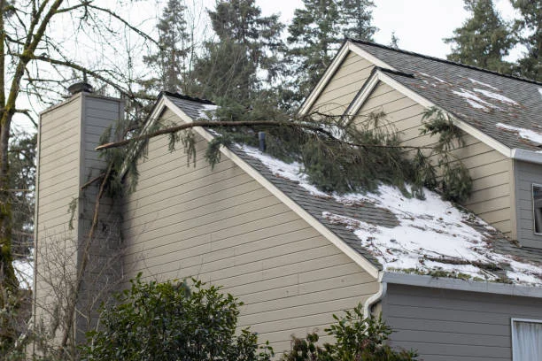 Roofer performing emergency roof repair after storm damage