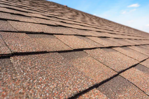 High-quality asphalt shingles providing durability, weather resistance, and aesthetic appeal for residential and commercial roofs.