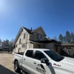 Roofer performing detailed inspection as part of comprehensive roofing services