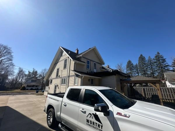 Roofer performing detailed inspection as part of comprehensive roofing services