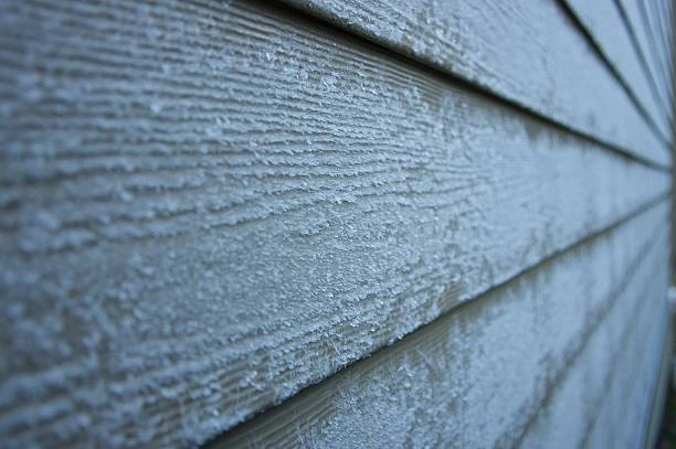 Fiber cement siding installed on a two-story home in a neutral tone