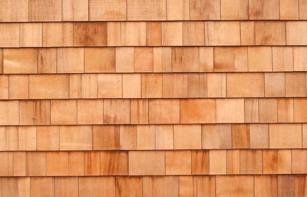 Skilled crew installing horizontal wood siding on a craftsman-style home