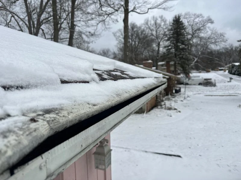 Roofing contractor inspecting hail damage during storm damage roof repair