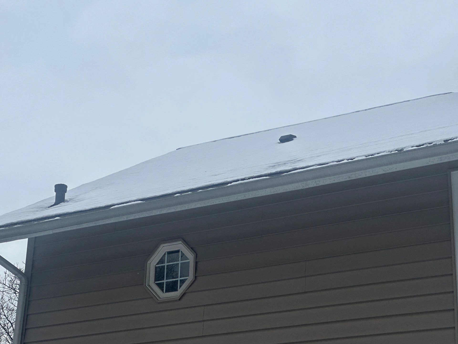 Cold upstairs in winter in a second-floor bedroom with a homeowner adjusting the thermostat to fix uneven heat in house.