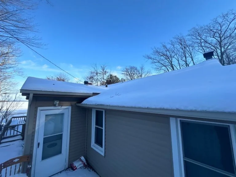 Icicles on your roof indicating possible ice dam and insulation issues – Worthy Construction LLC inspecting winter roof conditions