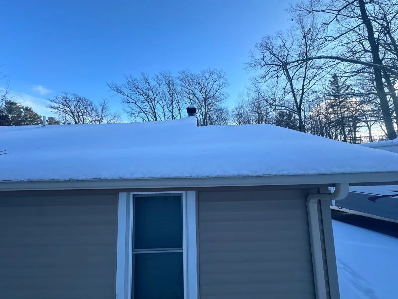 Why gutters freeze every winter: frozen gutters and ice buildup along roof edge and downspout