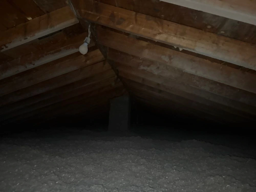Poor insulation in an attic causing heat buildup and moisture that shortens roof lifespan.