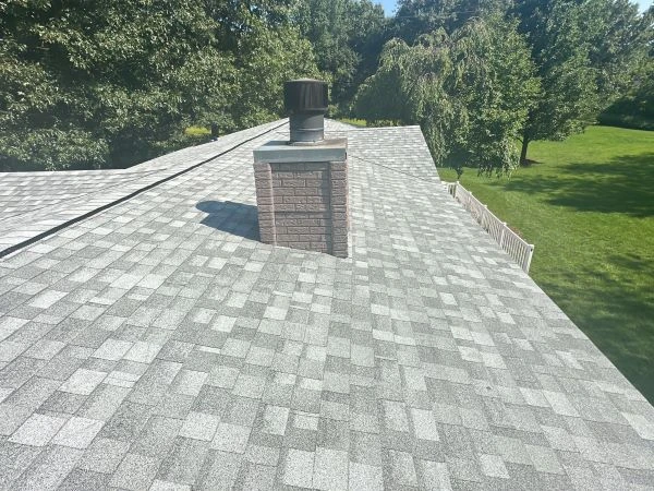 Roof oolor comparison showing light vs dark shingles on a residential home to illustrate energy efficiency and heat absorption differences.
