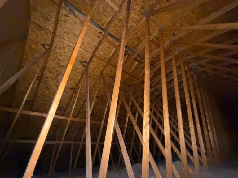 Attic moisture test showing condensation in attic on roof decking with attic moisture signs near bath fan duct and attic ventilation problems.