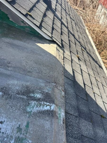 Shingle blow off showing missing asphalt shingles and exposed roof underlayment after strong wind damage on a residential roof.