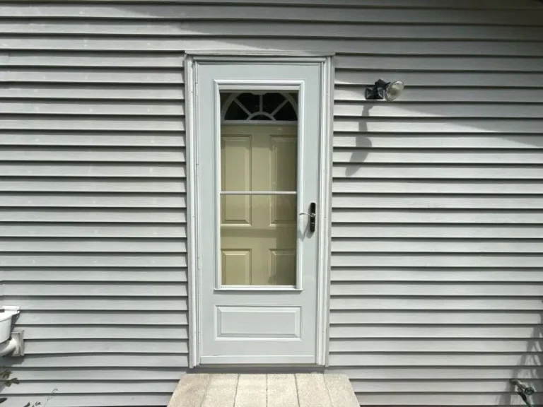 Exterior home with lower siding rots near the ground due to soil moisture, poor drainage, and repeated water splashback.