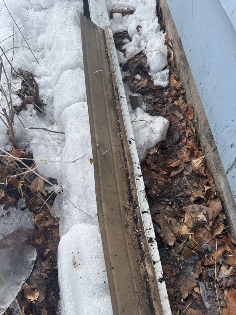 Improper gutter hanger spacing causing sagging gutters and water leaks along a home roofline