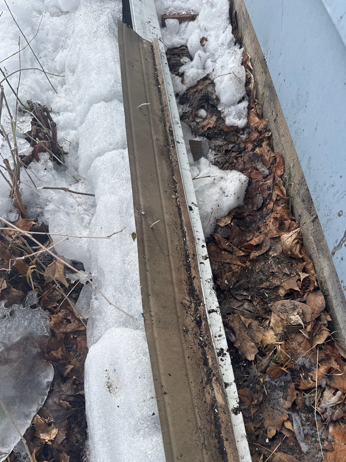 Improper gutter hanger spacing causing sagging gutters and water leaks along a home roofline