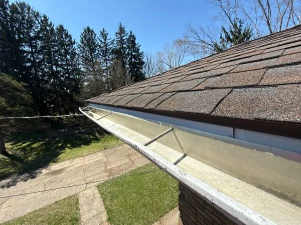 Rust spots forming on metal gutters due to moisture, debris buildup, damaged coating, and corrosion.