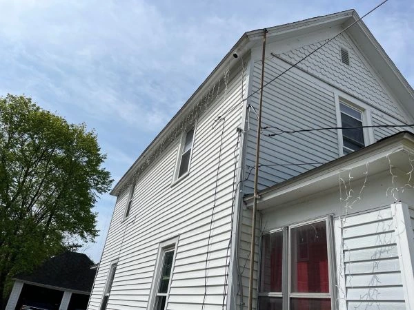 Siding damage causing water intrusion and moisture stains on interior walls of a home.